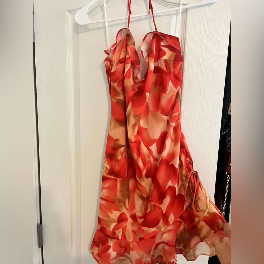 Red-Orange halter dress from White Fox Boutique with detailing on the side